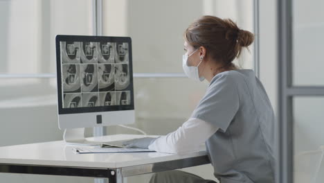 Female-Doctor-Watching-CT-Scan-on-Computer-in-Clinic